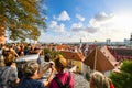 A crowd of tourists group together to take photos over Old Town Tallinn, Estonia from Toompea Hill.