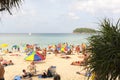 Crowd tourists, sunbed and umbrellas on the beach