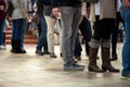 Crowd of unrecognizable people wait in line in a urban setting, outdoors