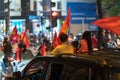 Crowd of Vietnamese football fans down the street to celebrate the win after soccer, with a lot of Vietnamese flags raising high