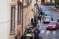 Crowd waiting in front of a Le Temps des Cerises logo on their store for Prague.