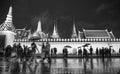 Crowd walking around grand palace in black and white