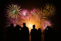 Crowd watching fireworks and celebration. Happy family sitting on floor and watching the fireworks Celebration at night on New Royalty Free Stock Photo