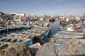 Crowd of wooden boats in a fishing port in northern Morocco with piled up fishing nets Royalty Free Stock Photo