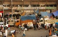 Crowd of workers and trucks in poor working area of indian city Kolkata