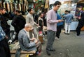 Crowd young and elderly people earn and spend money in the bazaar