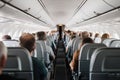 A crowded airplane with people sitting in the seats