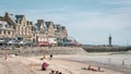 Crowded beach with people lounging on sand under colorful umbrellas, Cancale, France Royalty Free Stock Photo