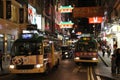 Crowded busy street with lots of buses in the evening in downtown Hong Kong