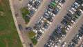 Crowded city parking drone view. Diverse cars riding at asphalt road to carpark Royalty Free Stock Photo