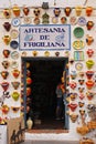 Crowded colorful pottery displayed on shop entrance at Frigiliana, Spain