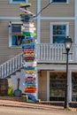 Crowded colourful signpost beside an old fashioned street lamp in Kennebunkport, Maine, USA Royalty Free Stock Photo