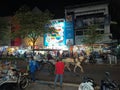 Crowded Malioboro streets at night with motorcycle, people, horse carriage, and bike rickshaw