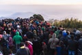 Crowded people are waiting for the first light in the dawn of new year`s day with mountain and fog in background at Tiger Hill.