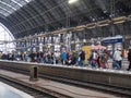 Crowded platform with people and trolleys inside Frankfurt station with steel glass roof Royalty Free Stock Photo