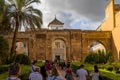 Crowded road to the main entrance gate of the Alcazar palace in Seville, Spain