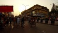 Crowded street in old Delhi row of auto-rickshaws rubbish on asphalt sunset