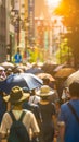 Crowded street with people using umbrellas to shield from the heat. Heatwave impact on daily life.