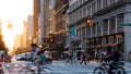 Crowded street scene with people, cars and bikes at the busy intersection of 23rd St and 5th Avenue in New York City