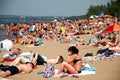 Crowded summer beach, people sunbathe in the sun