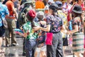 Crowded Thai people in colorful shirts and tourists joy Songkran Festival on the road