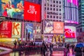 Crowded Times Square in Midtown Manhattan, New York, at Night. Bright LED Screens, Ads and Billboards. Urban Street Photography