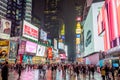 Crowded Times Square in New York City Manhattan at Night. Bright LED Screens and Billboards. Urban Street Photography