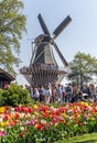 Crowded tourists before Wind mill in Keukenhoff tulip garden in Netherlands