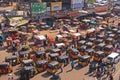 Crowded traffic with public transport auto rickshaw and fruit stall vendors