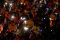 Crowded Vietnamese street at night, young people ride motorcycles in traffic jam Royalty Free Stock Photo