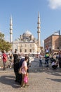 Crowds of citizens at Eminonu during the Victory Day holiday with the New Mosque in the background, Istanbul, Turkey