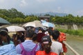 Crowds cross river on cable bridge