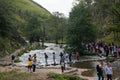 Crowds crossing the famous stepping stones at Dove Dale River Dove