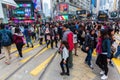 Crowds crossing King`s Road in Hong Kong Island