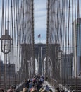 Crowds crossing the pedestrian walkway on the Brooklyn Bridge in New York City