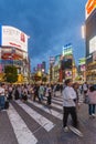 Crowds crossing Shibuya scramble crossing, the famous intersection in Tokyo outside Shibuya station