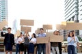 Crowds of discontented people holding blank banners placards protesting at downtown city, group of angry men and women rebellions Royalty Free Stock Photo