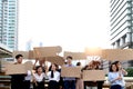 Crowds of discontented people holding blank banners placards protesting at downtown city, group of angry men and women rebellions Royalty Free Stock Photo