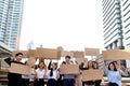 Crowds of discontented people holding blank banners placards protesting at downtown city, group of angry men and women rebellions Royalty Free Stock Photo