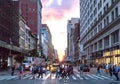 Crowds of diverse people cross the busy intersection on 23rd Street and 5th Avenue in Manhattan New York City