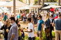 Crowds of diverse people sitting in the beer garden at outdoor farmer`s market