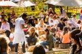 Crowds of diverse people sitting in the beer garden at outdoor farmer`s market