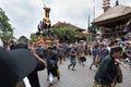 Balinese men carry the black bull sarcophagus during a procession for `Ngaben`, a cremation ceremony at Ubud, Bali, 2nd March 2018