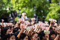 Crowds of mourners hold Thai cash for show picture of King Bhumibol during mourning ceremony