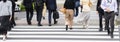 crowds of people crossing a city street on the zebra crossing in Tokyo, Japan Royalty Free Stock Photo