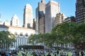 Crowds of people gather on the grass at Bryant Park for a summer