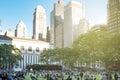 Crowds of people gather on the grass at Bryant Park for a summer