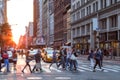 Crowds of people in motion across the busy intersection of 23rd Street and 5th Avenue in New York City