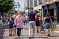 Crowds Of People Shoppers Or Customes Walking Along A Downtown High Street