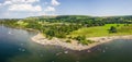 Crowds of people on a small lakeside beach in the middle of summer (Ullswater, Lake District, England